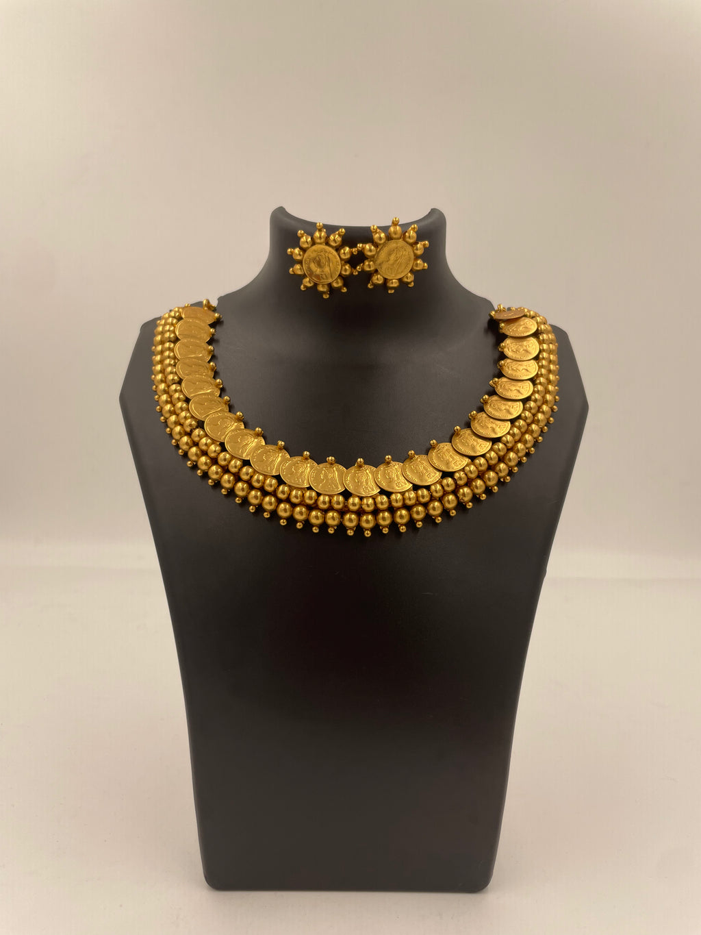 Vasudha Lakshmi kaasu mala necklace set with micro gold plating, Lakshmi coin motifs, golden bead detailing and matching stud earrings