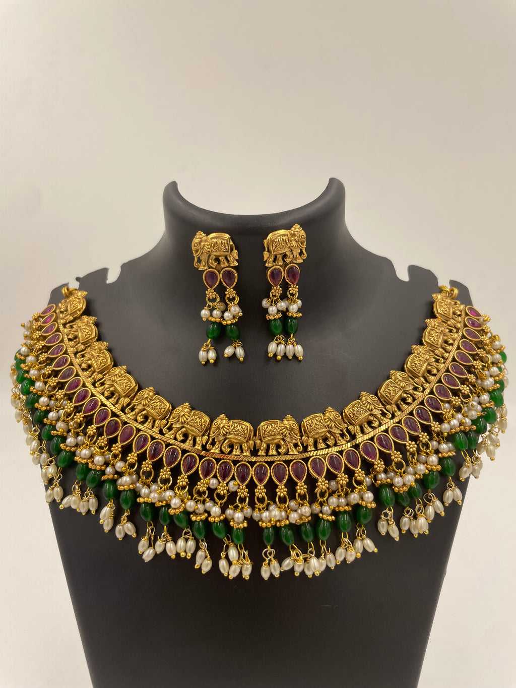 Vaidehi micro gold plated South Indian temple necklace set with ruby-coloured stones, green beads and pearl hangings with matching earrings