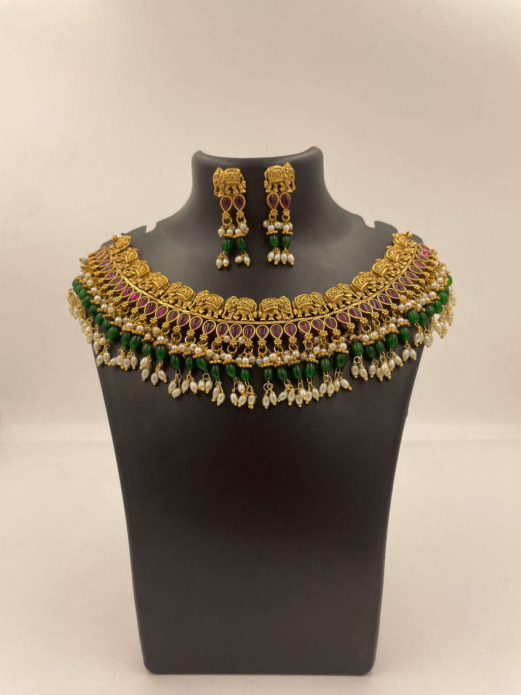 Vaidehi micro gold plated South Indian temple necklace set with ruby-coloured stones, green beads and pearl hangings with matching earrings