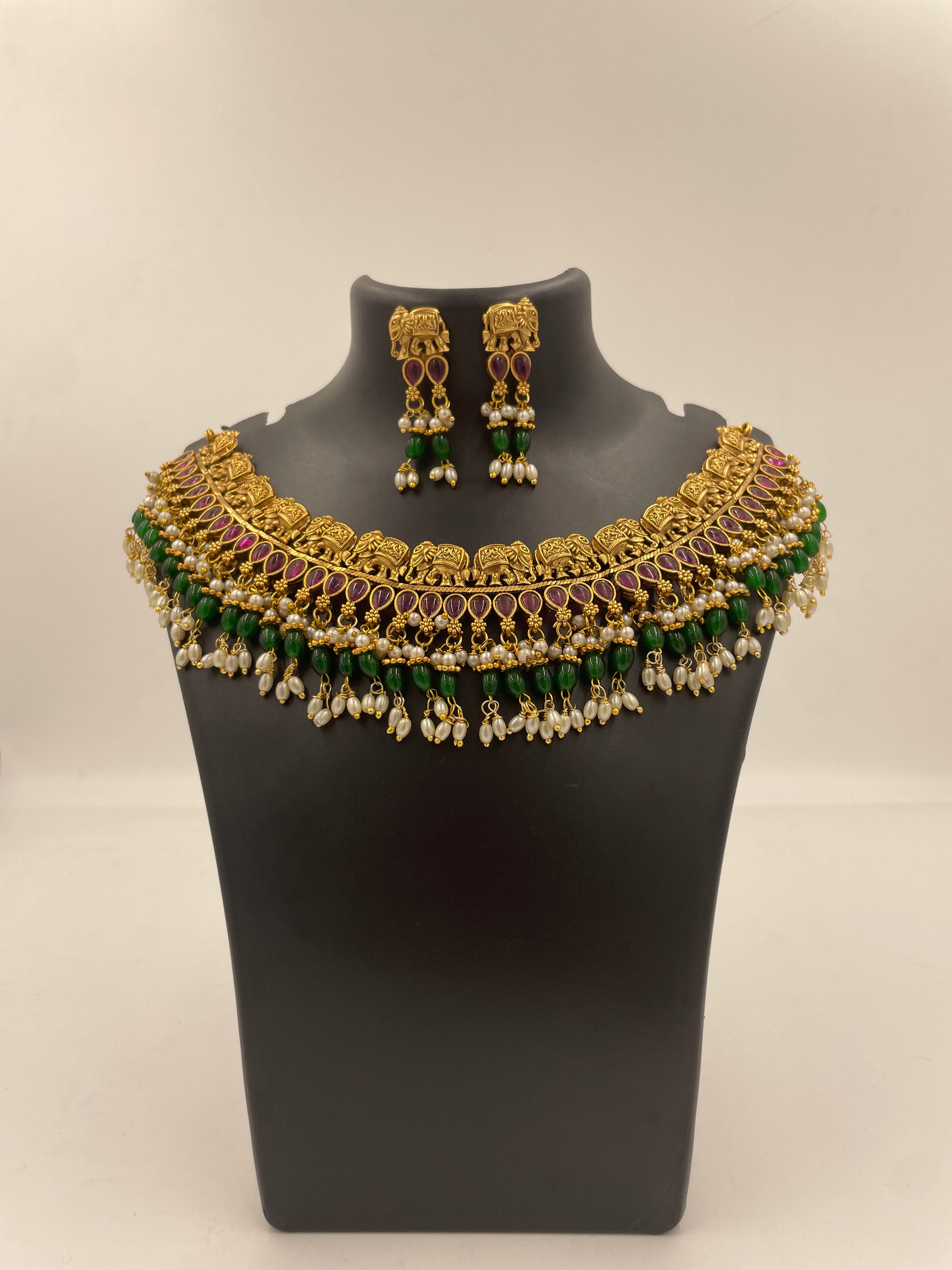 Vaidehi micro gold plated South Indian temple necklace set with ruby-coloured stones, green beads and pearl hangings with matching earrings