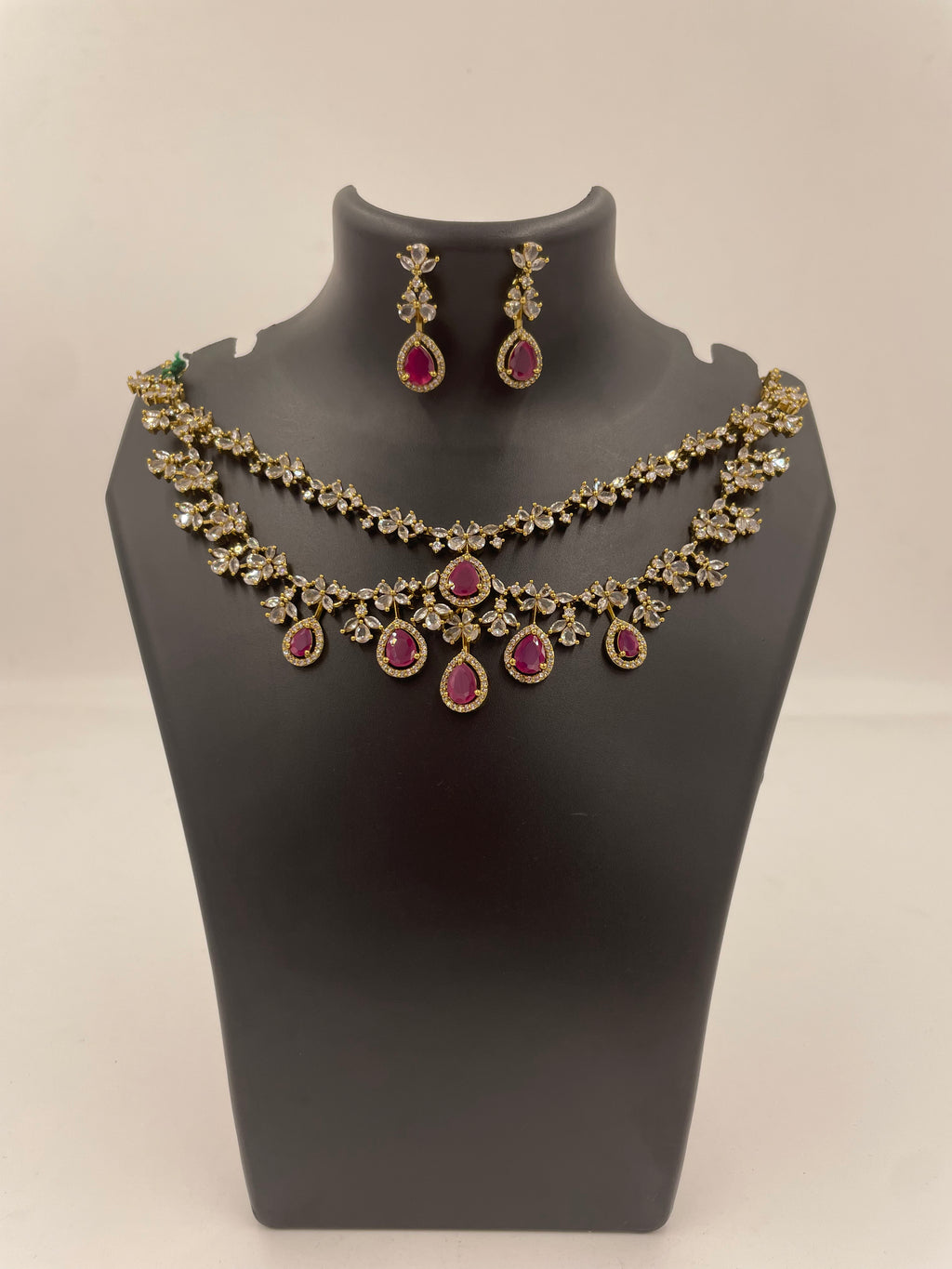 Aadhira double layer necklace set with ruby and white AD stones and matching earrings