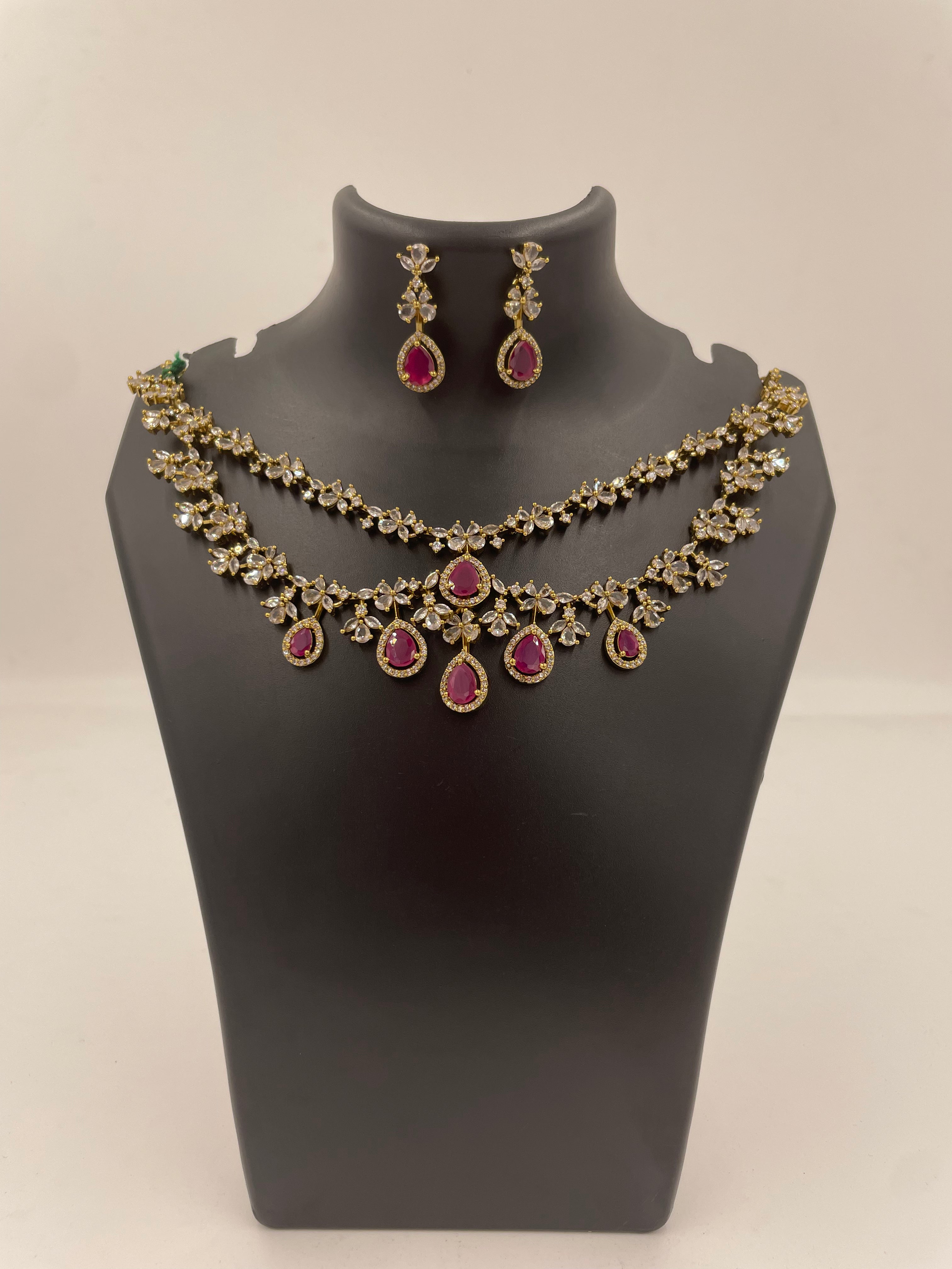 Aadhira double layer necklace set with ruby and white AD stones and matching earrings