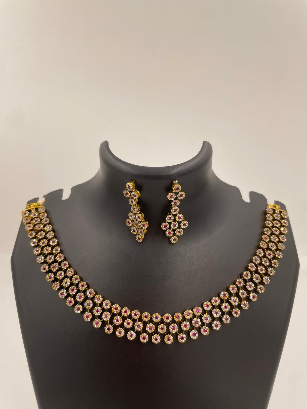 Aurelia premium ruby and white AD stone bridal necklace set with floral clusters and hanging earrings