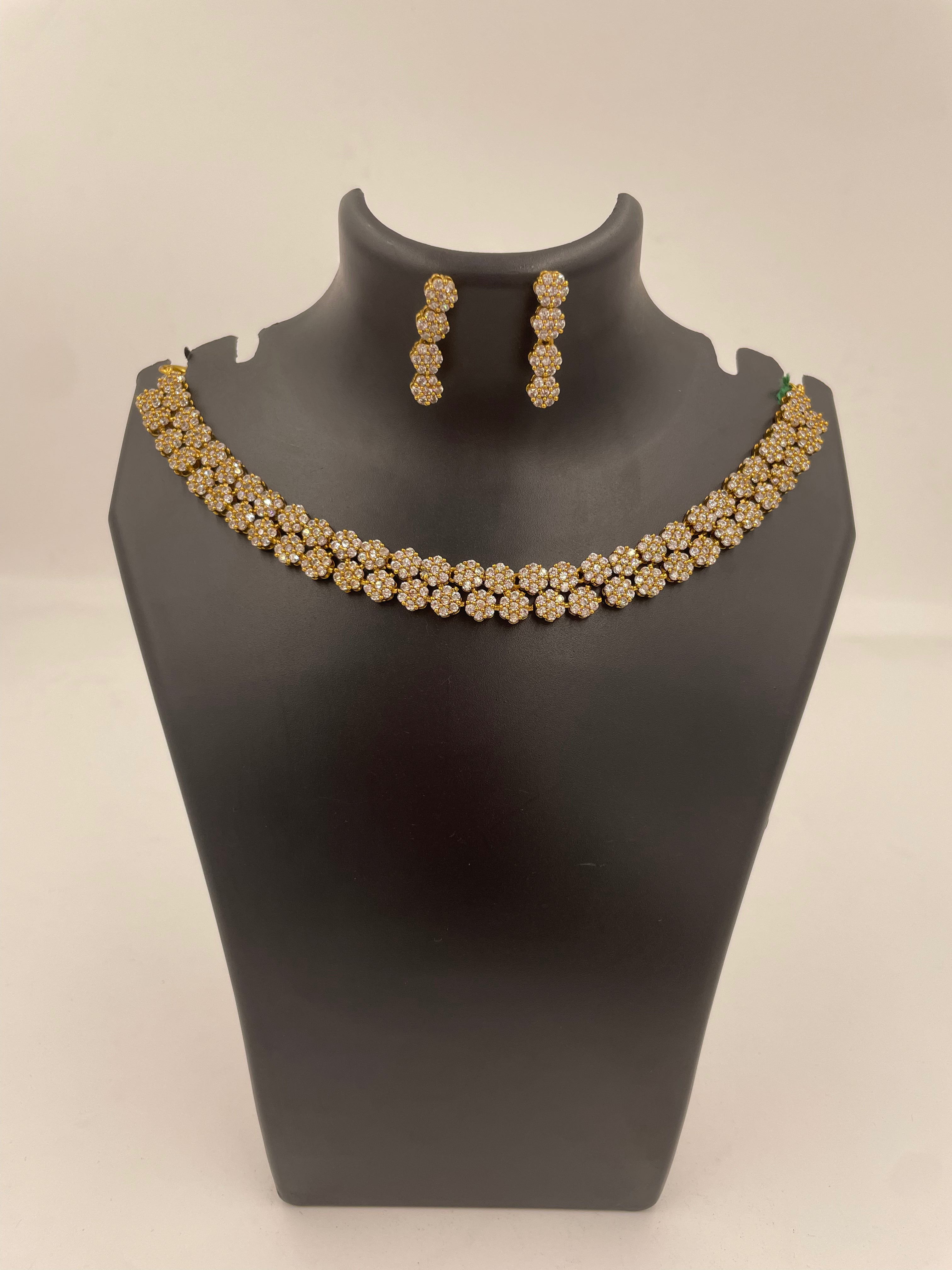 Anvi floral AD necklace set with sparkling white stones and matching earrings