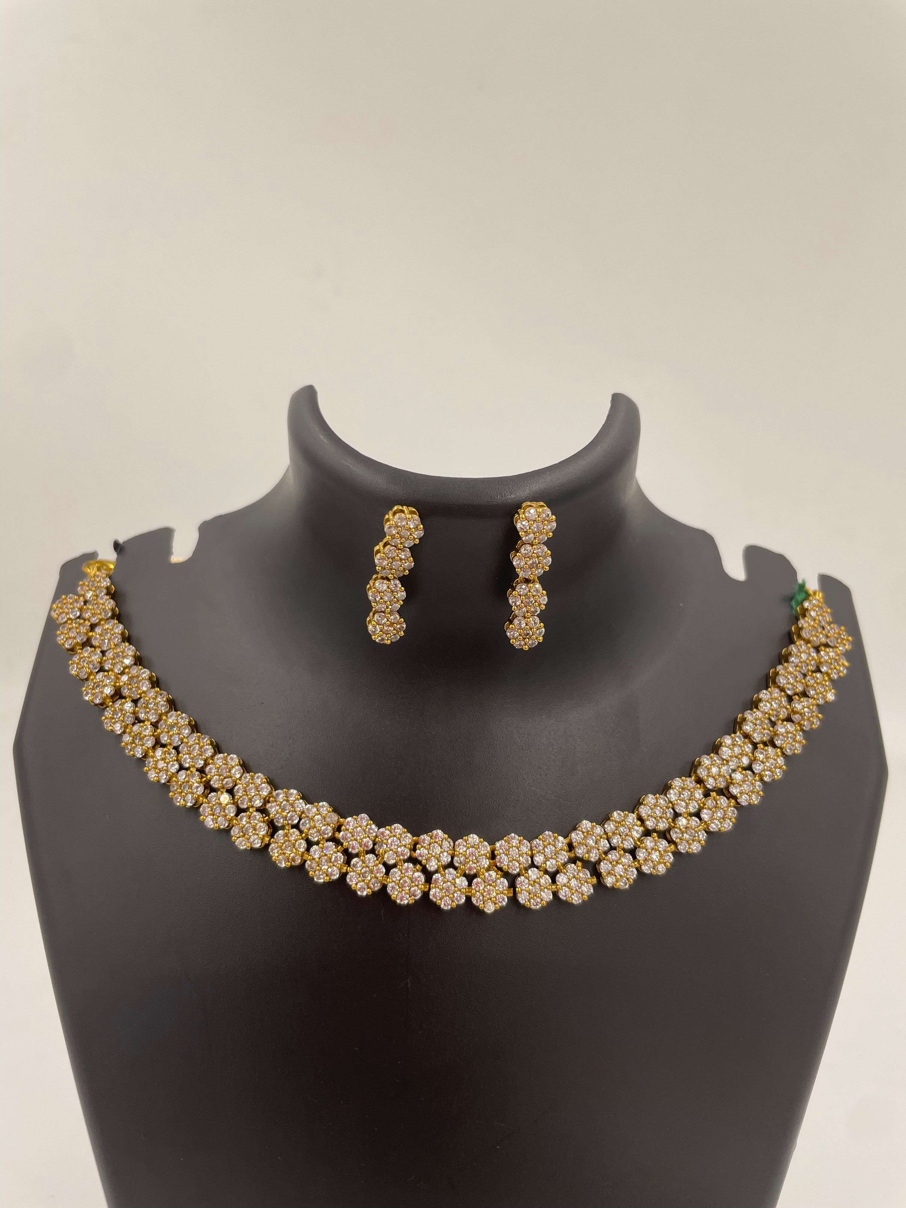 Anvi floral AD necklace set with sparkling white stones and matching earrings