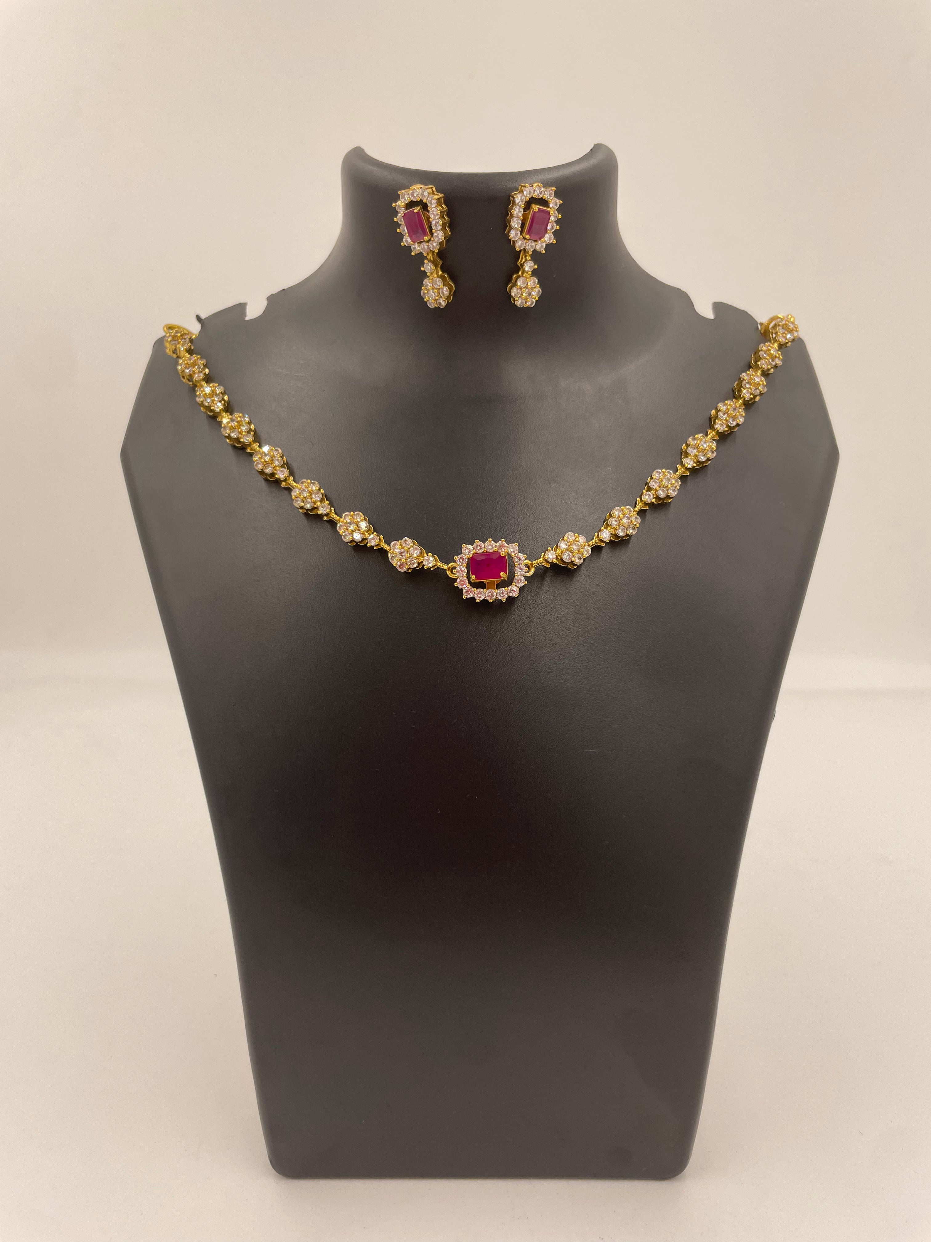 Ruby-toned floral AD necklace with matching drop earrings for wedding and festive wear