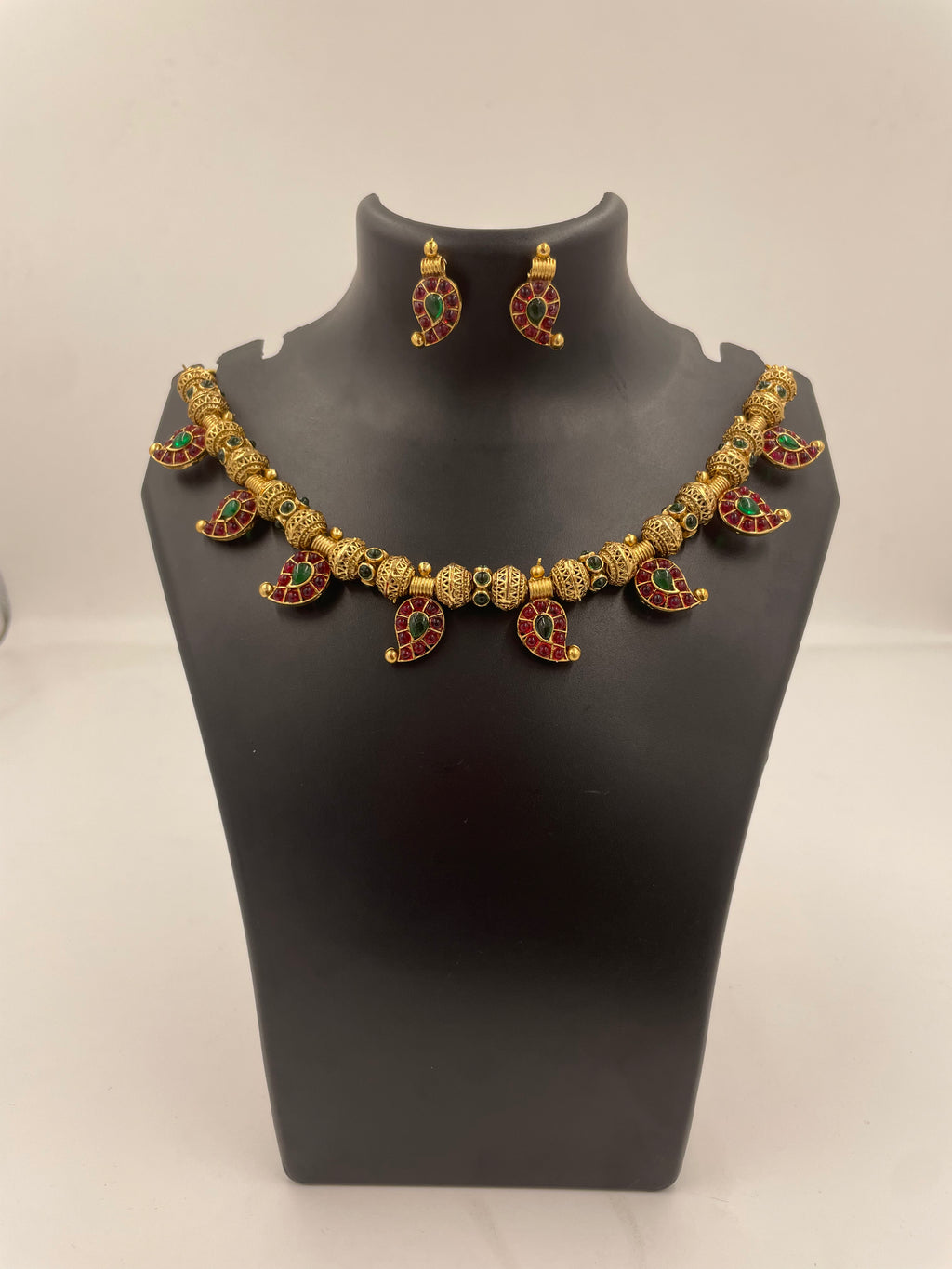 Aadhira gold micro plated mango mala necklace set with ruby-coloured and emerald-green semi-precious stones and matching earrings