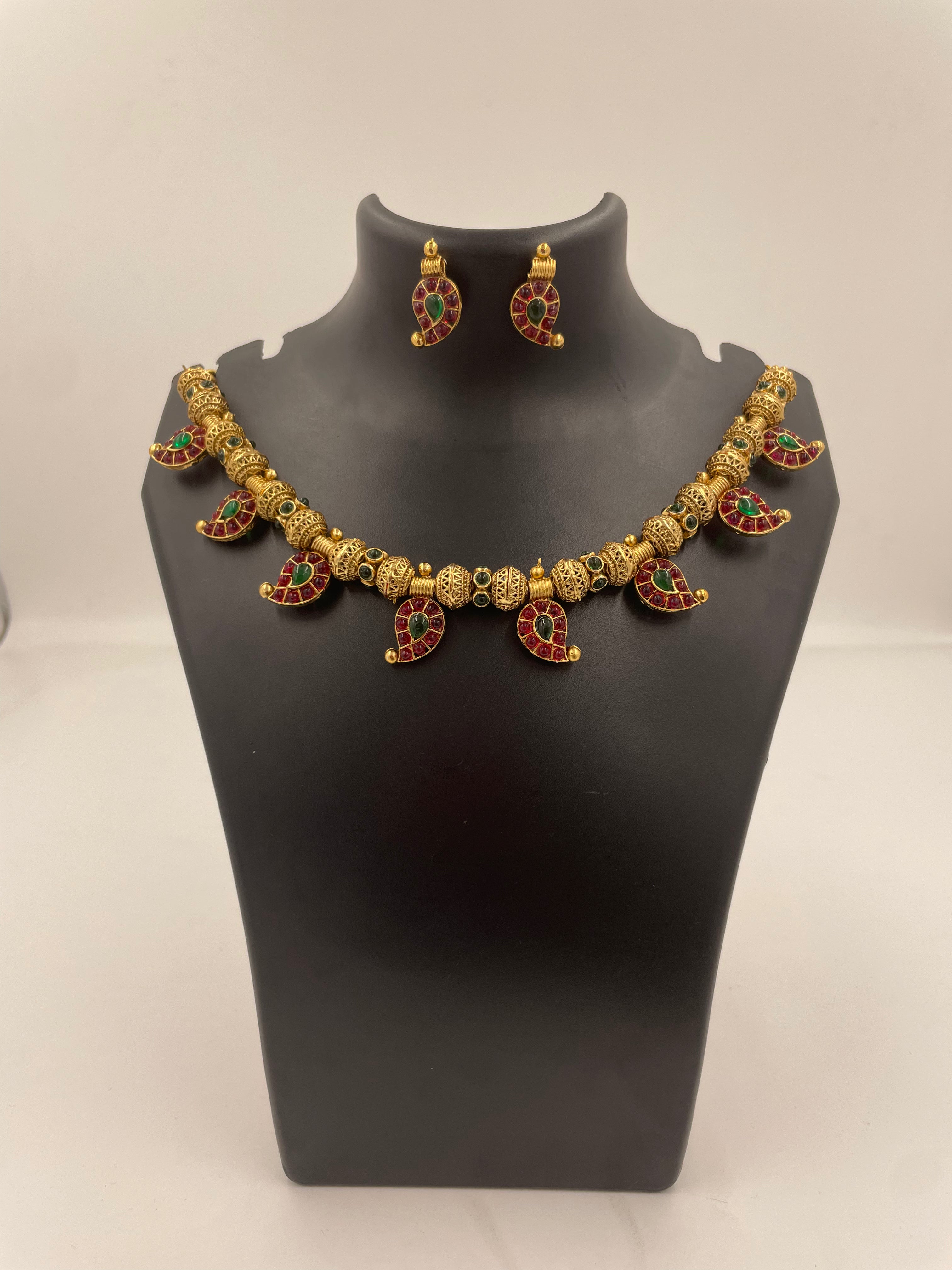 Aadhira gold micro plated mango mala necklace set with ruby-coloured and emerald-green semi-precious stones and matching earrings