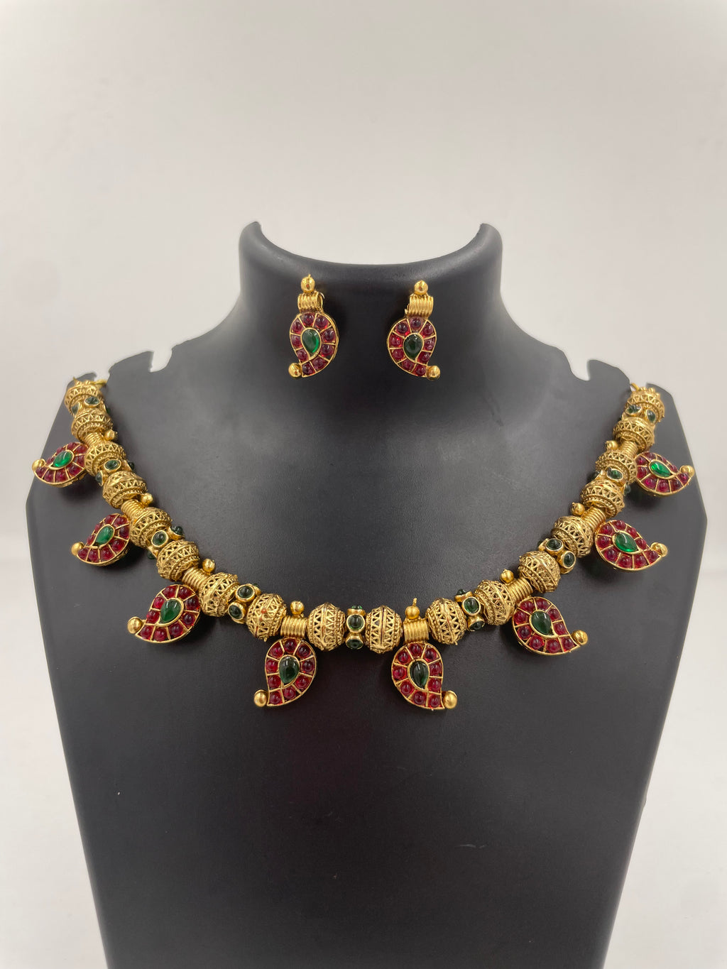 Aadhira gold micro plated mango mala necklace set with ruby-coloured and emerald-green semi-precious stones and matching earrings