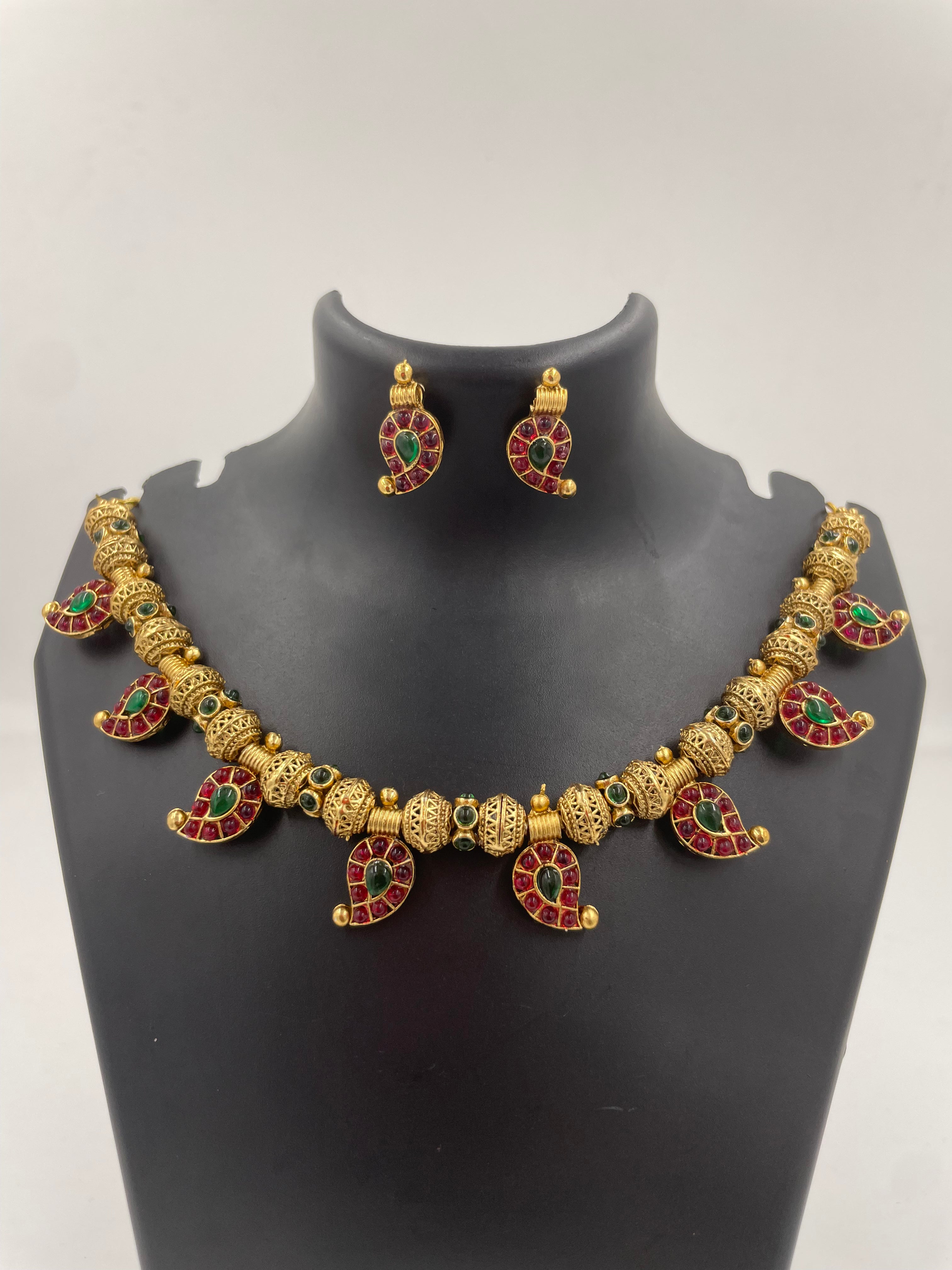 Aadhira gold micro plated mango mala necklace set with ruby-coloured and emerald-green semi-precious stones and matching earrings