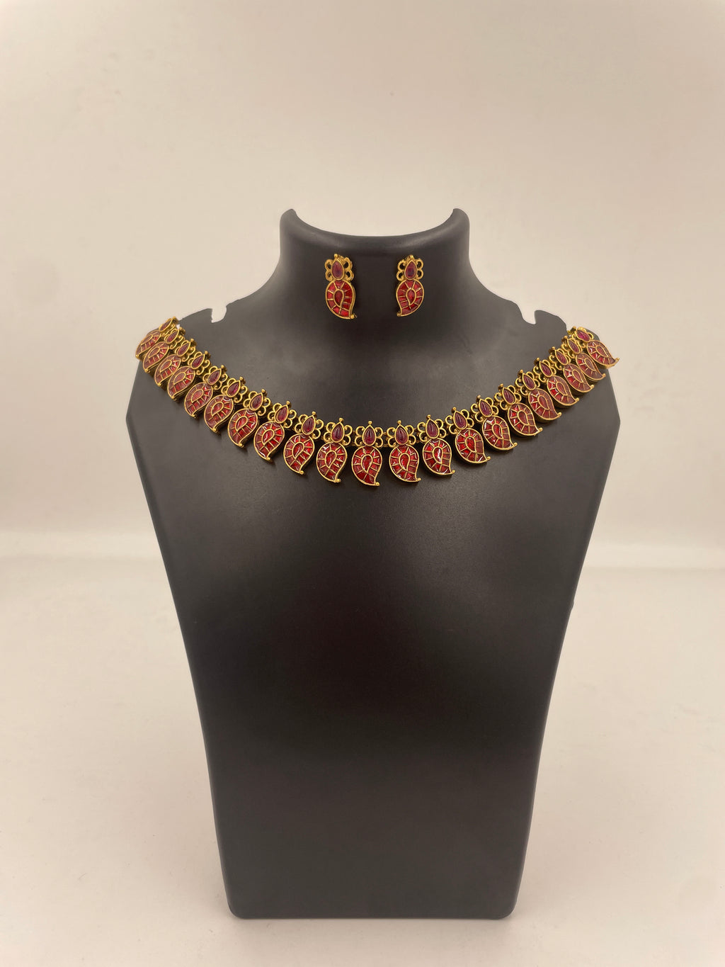 Amalu traditional Palakka necklace featuring maroon hand-painted enamel leaf motifs, gold-tone detailing and matching earrings