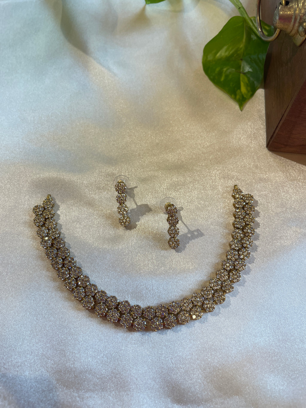 Anvi floral AD necklace set with sparkling white stones and matching earrings