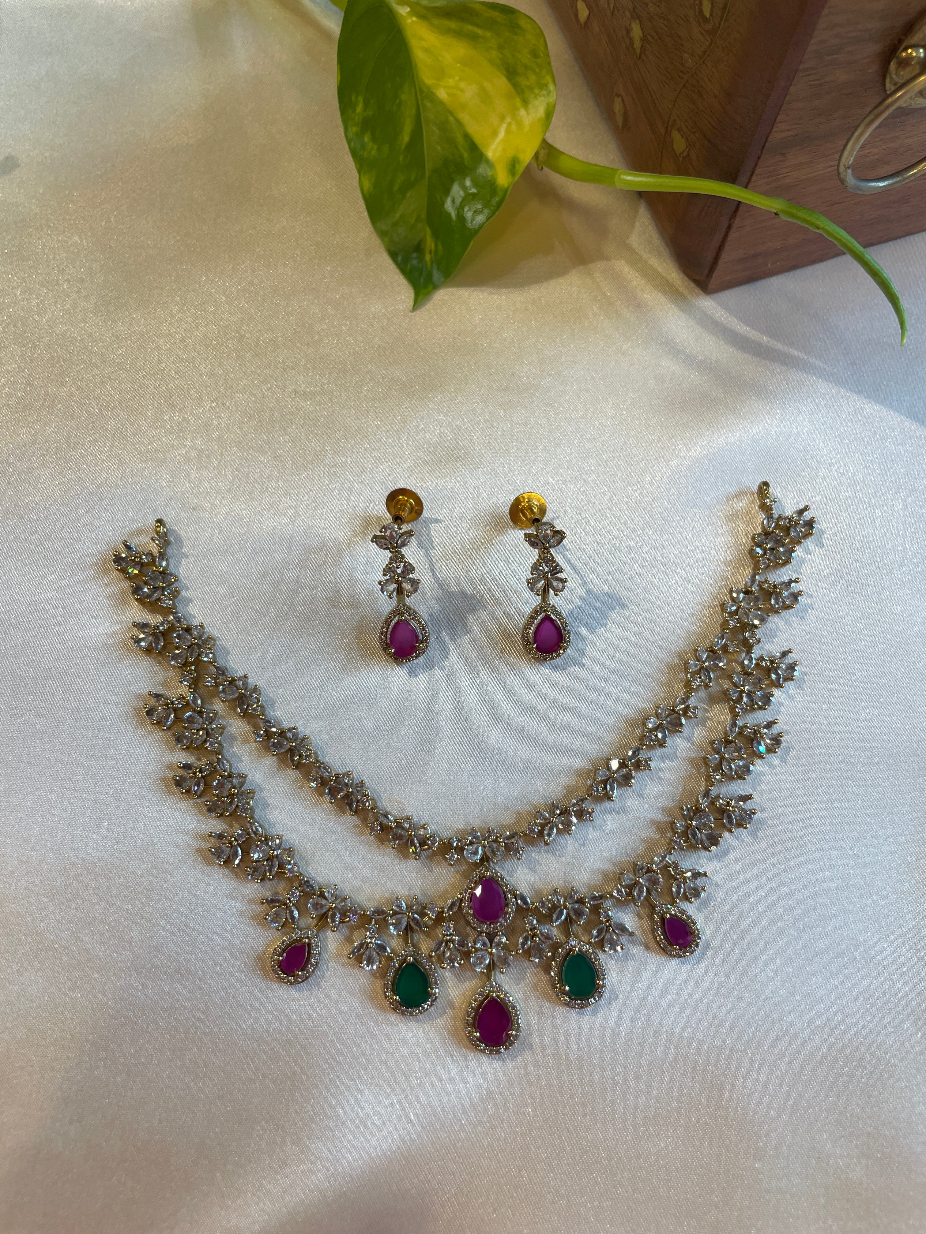 Aadhira double layer necklace set with pink and green teardrop stones and matching earrings