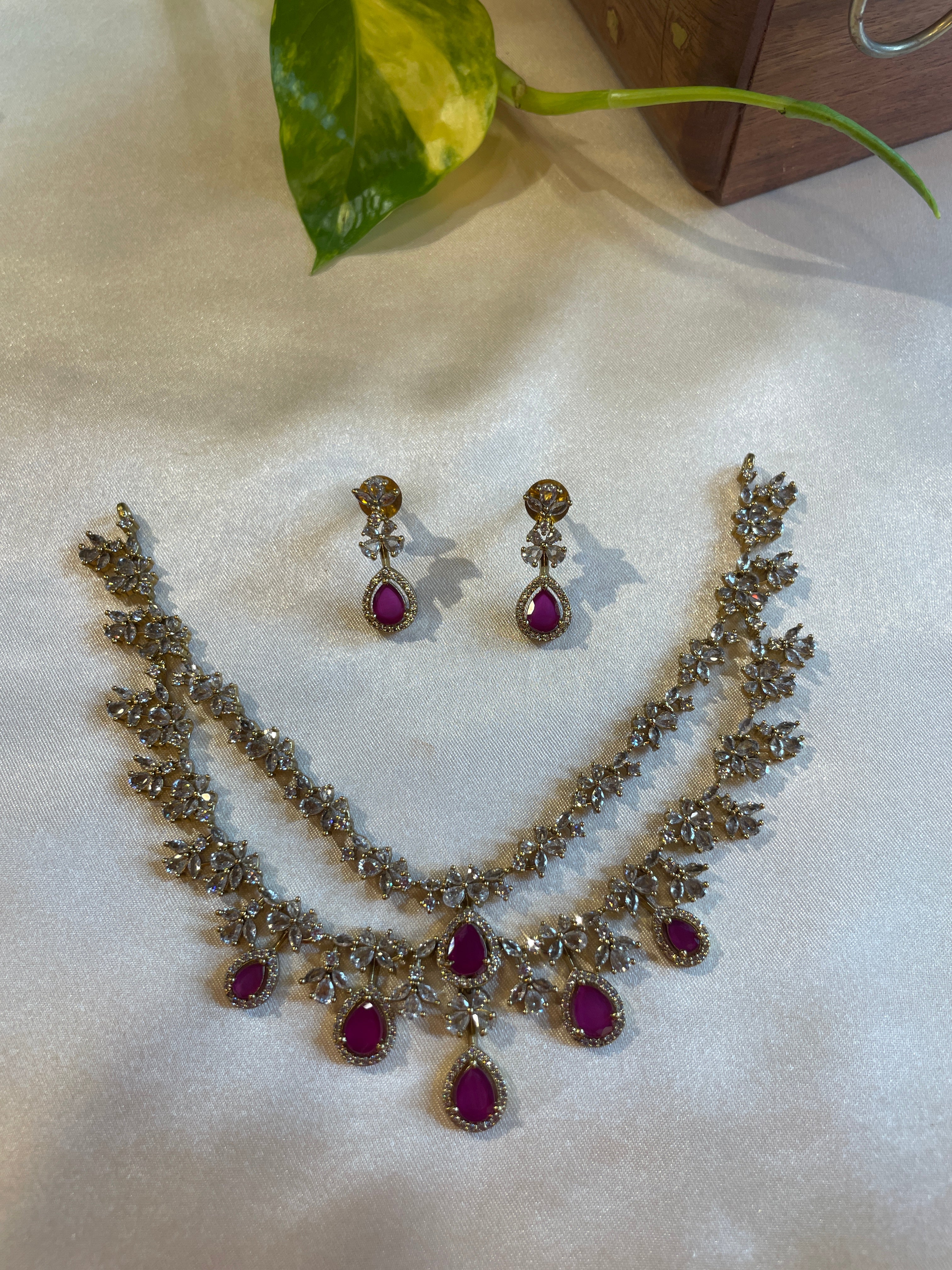 Aadhira double layer necklace set with ruby and white AD stones and matching earrings