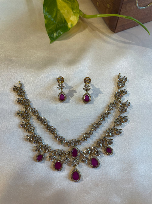 Aadhira double layer necklace set with ruby and white AD stones and matching earrings