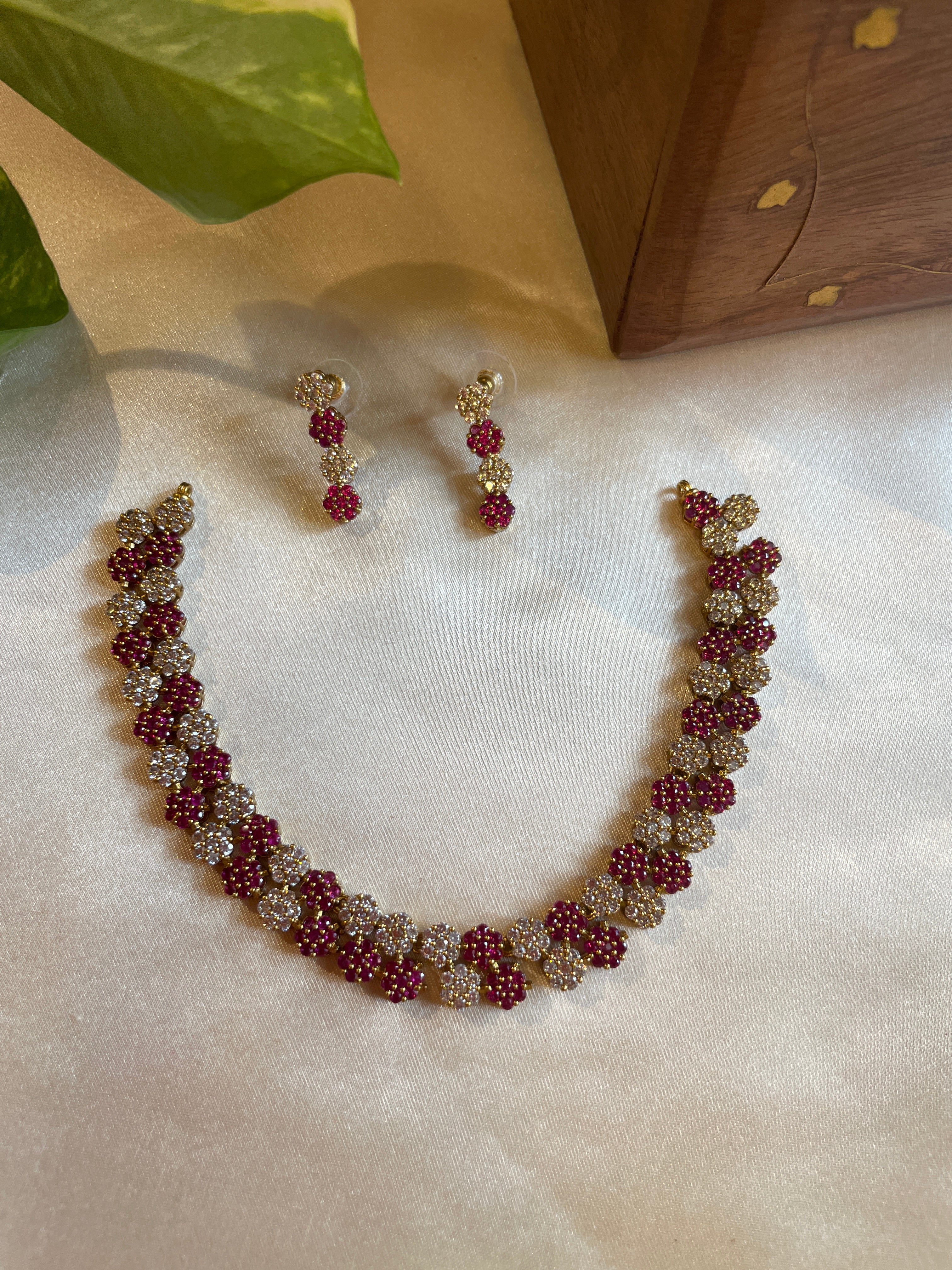 Diva Ruby Bloom necklace set with ruby and white AD stones and matching earrings