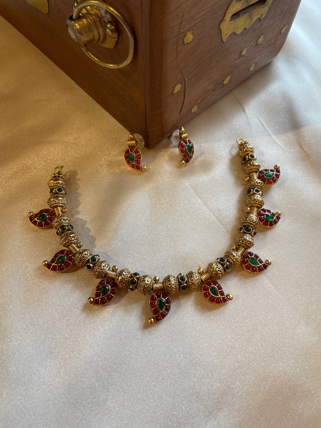 Aadhira gold micro plated mango mala necklace set with ruby-coloured and emerald-green semi-precious stones and matching earrings