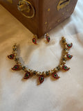 Aadhira gold micro plated mango mala necklace set with ruby-coloured and emerald-green semi-precious stones and matching earrings