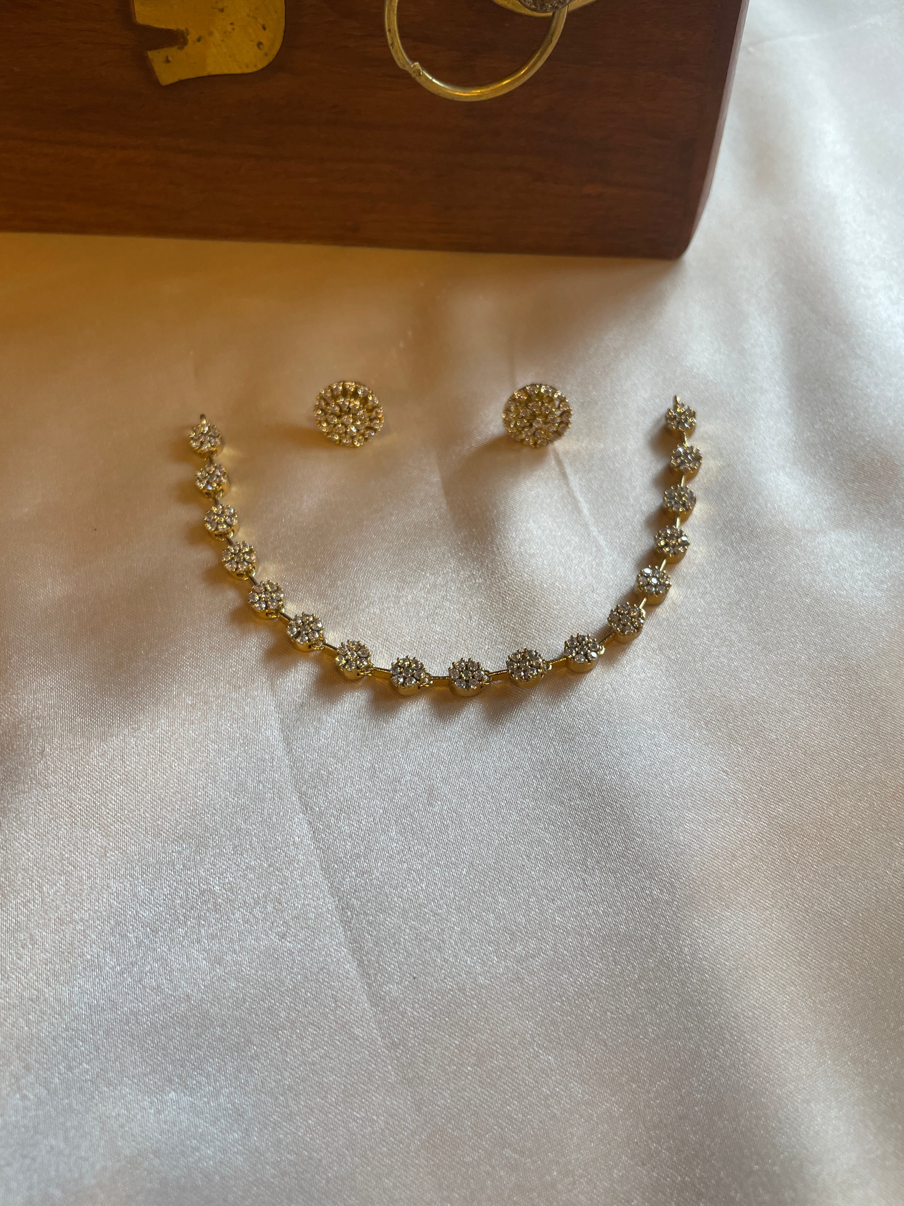 Delicate gold-tone floral AD necklace with matching stud earrings