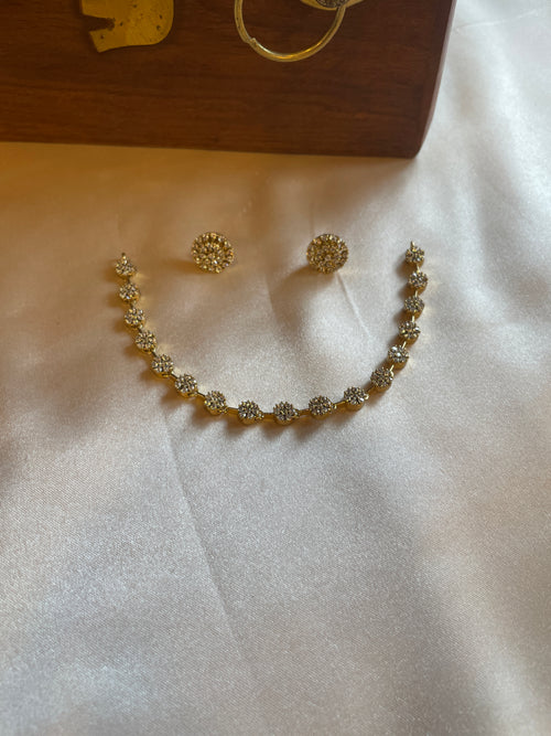 Delicate gold-tone floral AD necklace with matching stud earrings