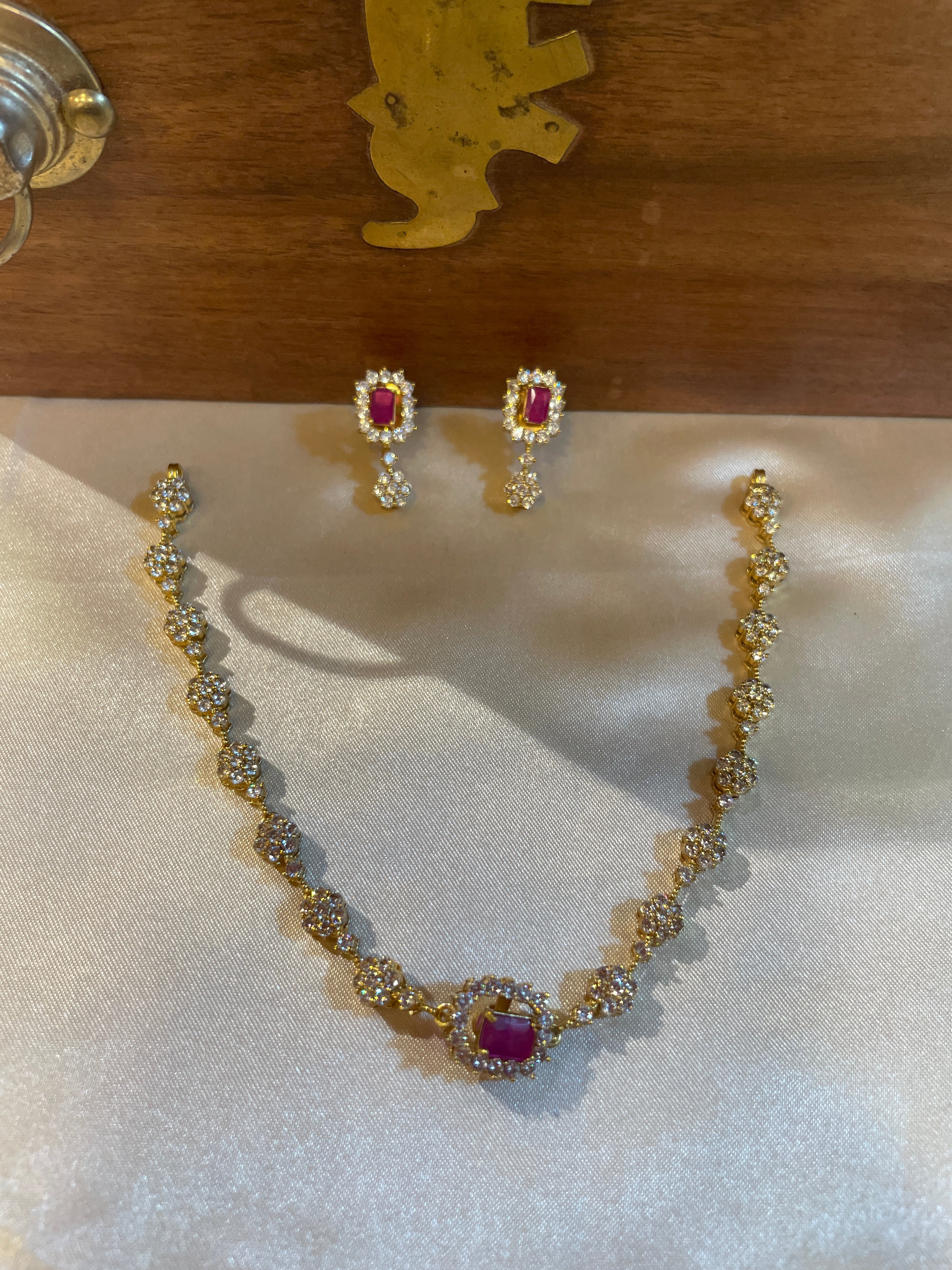 Ruby-toned floral AD necklace with matching drop earrings for wedding and festive wear