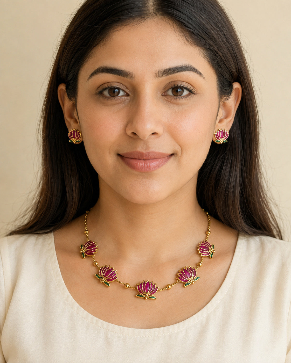 Padma gold-tone necklace with five pink lotus motifs, green leaves, and matching lotus stud earrings.