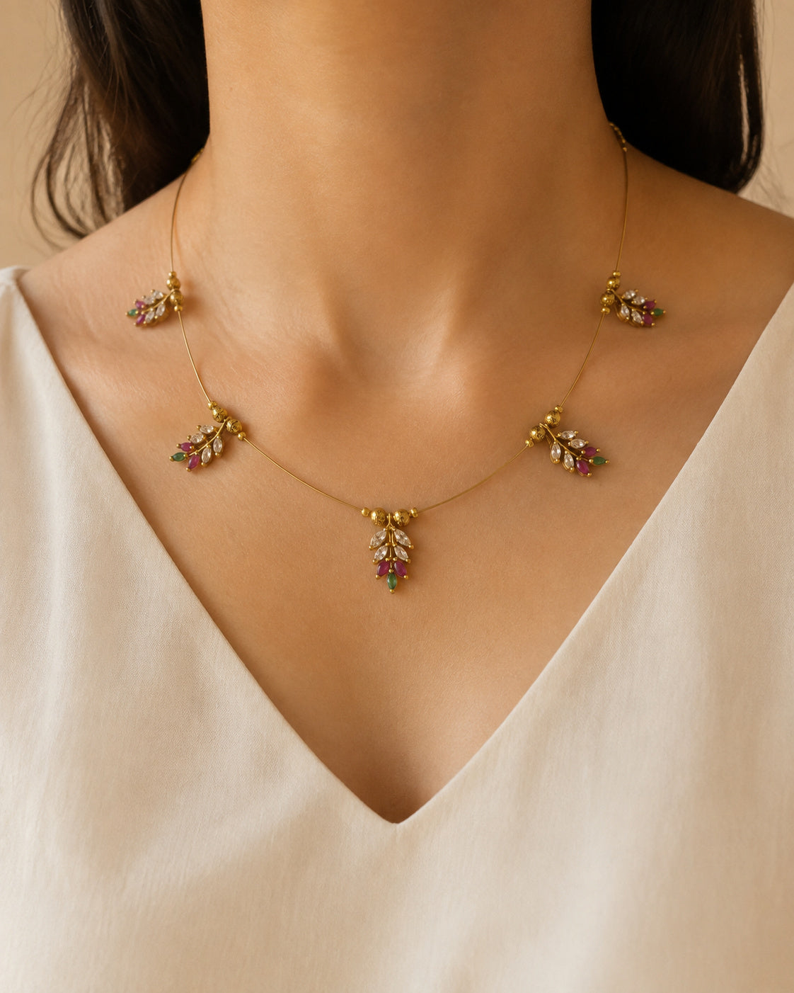 Anika multicolour AD stone gold microplated neckpiece with delicate leaf motifs.
